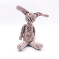 Load image into Gallery viewer, My First Bunny. Handmade with 100% organic cotton + 100% polyester fill. This toy has a rattle.  Ages 0+ older child. Approximately 22 cm length + 7.5 cm width. Made in Bangladesh for Refuge Brands.. Taupe.
