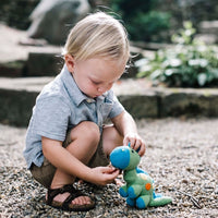 Load image into Gallery viewer, A stegosaurus dinosaur cotton knit toy. Featuring delicate little stitched details, this charming crochet dinosaur has a rattle
