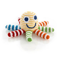 Load image into Gallery viewer,  A happy little sea creature is a little hands&#39; favorite! Our organic rainbow octopus rattle is colorful.
