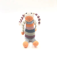 Load image into Gallery viewer, Our floppy-eared, multi-striped rainbow bunny has to be the brightest rattle in town! Featuring all the colors in our organic cotton range, he’s fun, friendly and fully machine-washable. Hand-knitted 
