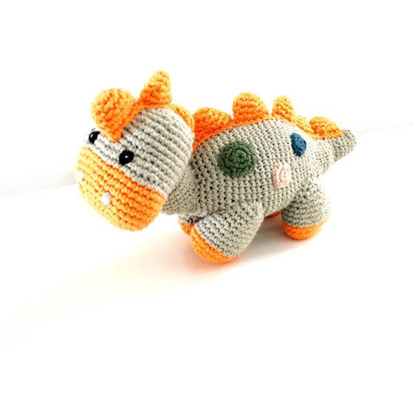 A stegosaurus dinosaur cotton knit toy. Featuring delicate little stitched details, this charming crochet dinosaur has a rattle . Teal Steggy.